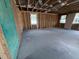 Unfinished basement with exposed wood frame and concrete flooring offers potential for customization at 30108 Misty Pines Rd, Mount Dora, FL 32757