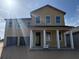 Two story home with large windows and a two car garage is bathed in sunlight at 30108 Misty Pines Rd, Mount Dora, FL 32757