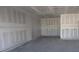 Spacious unfinished garage with bare drywall offers plenty of room for vehicles and storage at 30108 Misty Pines Rd, Mount Dora, FL 32757