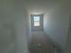 A hallway showcases a window at the end, offering a glimpse of the neighborhood outside at 30108 Misty Pines Rd, Mount Dora, FL 32757