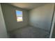 A bedroom featuring neutral walls and a window with a view of the outdoors at 30162 Rustic Mill St, Mount Dora, FL 32757