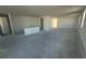 An open floor plan featuring concrete floors, bright natural light, and smooth white walls at 30162 Rustic Mill St, Mount Dora, FL 32757