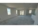 Open-concept room with smooth floors, white walls, and plenty of light from multiple windows at 30162 Rustic Mill St, Mount Dora, FL 32757
