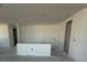 Bright, airy living area featuring smooth concrete floors and pristine white walls at 30162 Rustic Mill St, Mount Dora, FL 32757