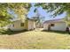 Spacious backyard featuring a well-maintained lawn, detached garage, and sunny skies at 311 E Wallace St, Orlando, FL 32809