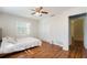 Well-lit bedroom featuring wood floors, a ceiling fan, and a closet with sliding doors at 311 E Wallace St, Orlando, FL 32809