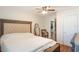 Bright bedroom featuring wood-look floors, a large bed, and a view through the doorway to a closet at 311 E Wallace St, Orlando, FL 32809