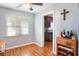 Bright dining area with hardwood floors, a ceiling fan, and a view into the kitchen at 311 E Wallace St, Orlando, FL 32809