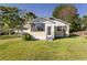 Charming single-story home with a screened porch and well-maintained front yard at 311 E Wallace St, Orlando, FL 32809