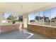 Enclosed sunroom featuring brick base, full windows and views of the fenced yard at 311 E Wallace St, Orlando, FL 32809