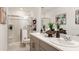 Bright bathroom featuring double sinks, granite countertops, and a glass-enclosed shower at 3158 Skyline Loop, Kissimmee, FL 34758