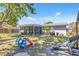 Large backyard offers outdoor dining and lounge spaces with a screened-in porch for alfresco entertaining at 3420 Arnel Dr, Winter Park, FL 32792