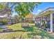 Expansive backyard features a picnic table, tree swing, and covered porch ideal for fun outdoor activities at 3420 Arnel Dr, Winter Park, FL 32792