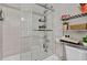 A well-maintained bathroom with a shower-tub combo, glass door, and vanity storage at 3420 Arnel Dr, Winter Park, FL 32792