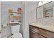 A stylish bathroom featuring a modern vanity with granite countertop, mirror, and shelf at 3420 Arnel Dr, Winter Park, FL 32792