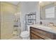 This updated bathroom has a glass enclosed shower, modern vanity, and sleek fixtures at 3420 Arnel Dr, Winter Park, FL 32792