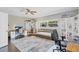 Neutral bedroom with built-in shelving, a ceiling fan and large windows for natural light at 3420 Arnel Dr, Winter Park, FL 32792