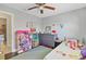 Bright bedroom with a comfortable bed, dark wood floors, and ample space for a dollhouse at 3420 Arnel Dr, Winter Park, FL 32792
