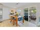 Cozy dining area with wood table, blue chairs, and sliding glass doors to the screened lanai at 3420 Arnel Dr, Winter Park, FL 32792
