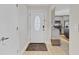 Light and bright entryway with a white front door and a glimpse of the kitchen at 3420 Arnel Dr, Winter Park, FL 32792