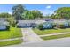 Well-kept home with a long driveway, healthy green lawn and mature landscaping at 3420 Arnel Dr, Winter Park, FL 32792