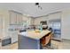 Bright kitchen with stainless steel appliances, granite countertops, and a stylish gray kitchen island at 3420 Arnel Dr, Winter Park, FL 32792