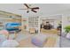 Open-concept living room with plenty of natural light, TV, and view into a modern kitchen at 3420 Arnel Dr, Winter Park, FL 32792