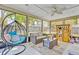Inviting sunroom features a modern egg chair, comfortable seating, and playhouse for relaxing or entertaining at 3420 Arnel Dr, Winter Park, FL 32792