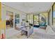 Relaxing sunroom features comfortable seating and seamless transition to the indoors for entertainment at 3420 Arnel Dr, Winter Park, FL 32792