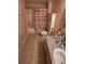 Bathroom featuring a tiled floor, cabinet above the toilet, and shower with curtain at 3433 Soho St # 101, Orlando, FL 32835