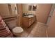 Bathroom featuring a tiled floor, cabinet above the toilet, and vanity at 3433 Soho St # 101, Orlando, FL 32835