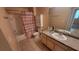 Bathroom with vanity, cabinet above the toilet, tiled floor, and shower with curtain at 3433 Soho St # 101, Orlando, FL 32835