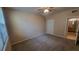 Carpeted bedroom featuring a ceiling fan, window and an ensuite bathroom at 3433 Soho St # 101, Orlando, FL 32835