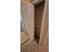 Linen closet with wire shelving adjacent to a closet with louvered doors and tiled floors at 3433 Soho St # 101, Orlando, FL 32835