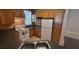 A kitchen with white appliances, wood cabinets, and a gray countertop at 3433 Soho St # 101, Orlando, FL 32835