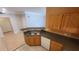 An open concept kitchen with wood cabinets and a gray countertop at 3433 Soho St # 101, Orlando, FL 32835
