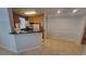 Kitchen and dining area with tile floors, a breakfast bar, and wooden cabinets at 3433 Soho St # 101, Orlando, FL 32835
