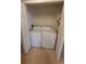 Laundry closet with washer and dryer and wire rack at 3433 Soho St # 101, Orlando, FL 32835