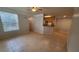 Bright living room with tiled floors flowing into an open kitchen area with a breakfast bar at 3433 Soho St # 101, Orlando, FL 32835