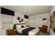 Relaxing bedroom featuring dark accents, a plush bed, and modern lighting at 404 Wayland Dr, Haines City, FL 33844