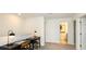 Hallway with office furniture setup, neutral paint, and bright lighting near rooms at 404 Wayland Dr, Haines City, FL 33844
