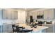 Modern kitchen featuring stainless steel appliances, stone countertops, bar seating, and gray shaker cabinets at 404 Wayland Dr, Haines City, FL 33844