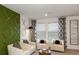 Bright living room with modern decor, stylish accent wall, and comfortable seating by the windows at 404 Wayland Dr, Haines City, FL 33844