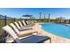 Community pool area featuring plenty of lounge chairs and umbrellas on a sunny day at 404 Wayland Dr, Haines City, FL 33844