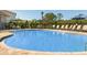 Inviting community pool with ample lounge seating and shade umbrellas for relaxation at 404 Wayland Dr, Haines City, FL 33844