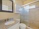 Elegant bathroom featuring a vanity with granite counters, cabinets for storage, and a walk-in shower at 405 Carriage Way Ct, Oviedo, FL 32765