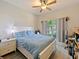 Comfortable bedroom features a ceiling fan, with a bed and desk and view to the outside at 405 Carriage Way Ct, Oviedo, FL 32765