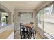 Sun-drenched breakfast nook featuring a square table, bar stools, and large windows with views of the pool at 405 Carriage Way Ct, Oviedo, FL 32765