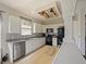 Modern kitchen featuring white cabinets, granite countertops, stainless steel appliances, and a stylish subway tile backsplash at 405 Carriage Way Ct, Oviedo, FL 32765