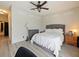 Spacious main bedroom with a tufted headboard, ceiling fan and neutral walls, with wood-look floors at 405 Carriage Way Ct, Oviedo, FL 32765